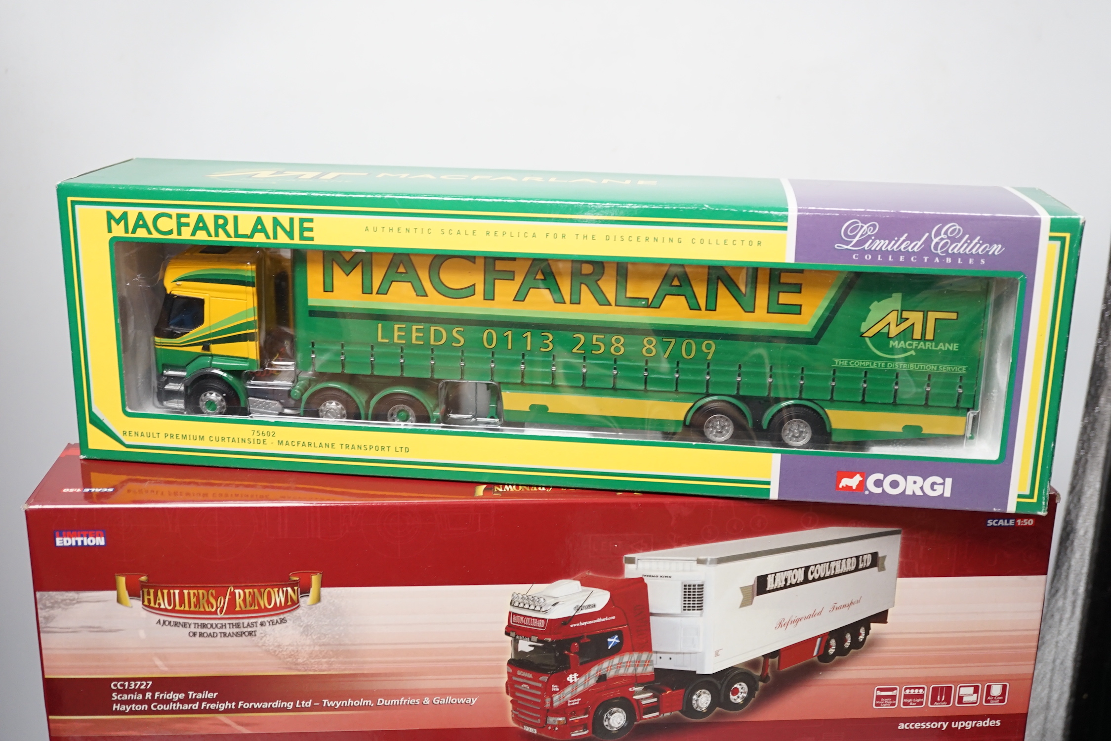 Four boxed Corgi and Universal Hobbies 1:50 scale articulated trucks; a Scania refrigerated lorry (CC13727), Scania Topline refrigerated lorry (CC12922), a Renault Premium Curtainside (75602), and another Scania Topline